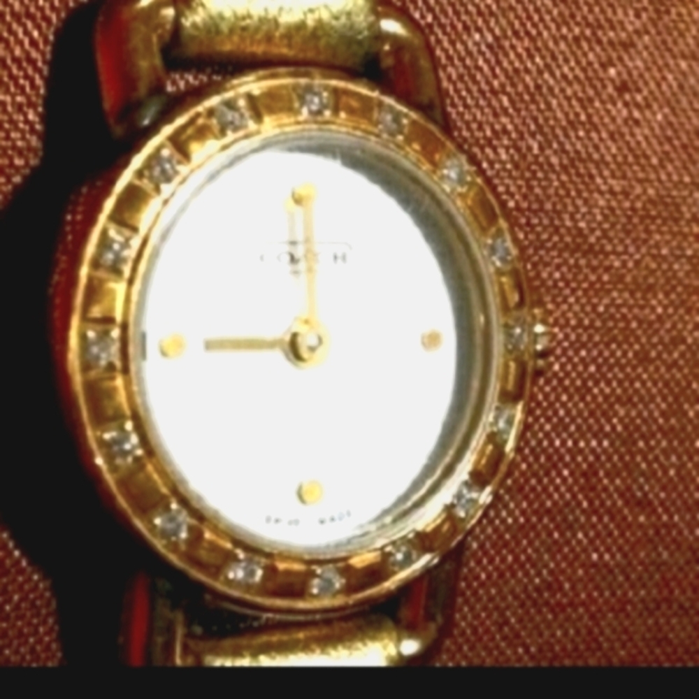 Coach watch has Mother of Pearl face with real dia
